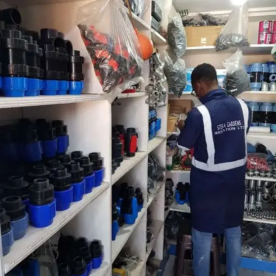 Staff member sorting irrigation fittings in the equipment stock room